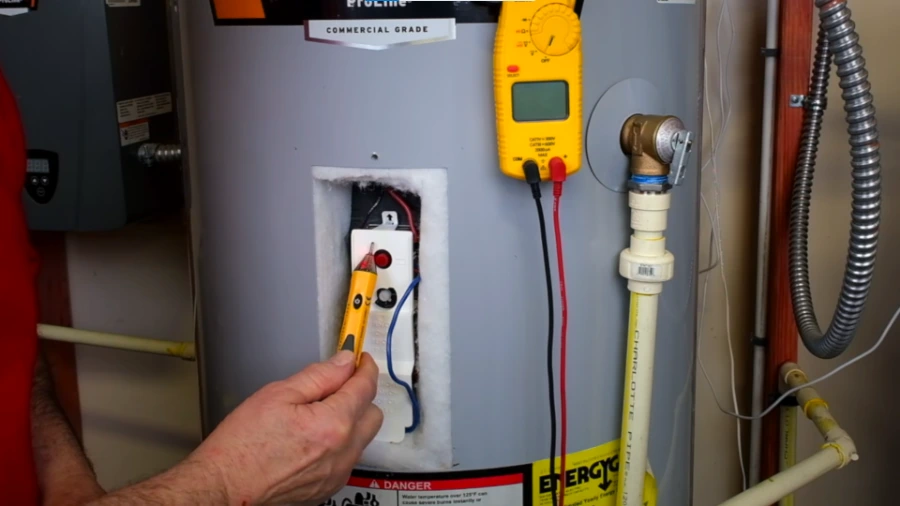 Testing voltage on an electric water heater during a Torrance service call